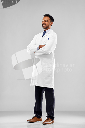 Image of smiling male doctor or scientist in white coat