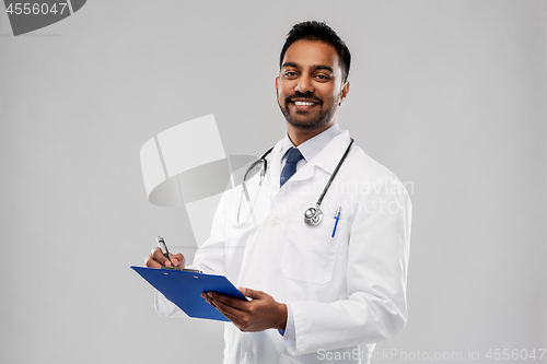 Image of indian male doctor with clipboard and stethoscope