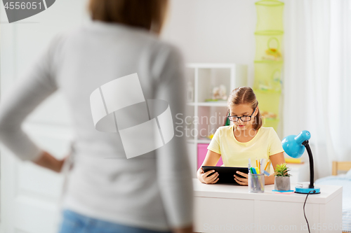 Image of student girl using tablet computer during homework