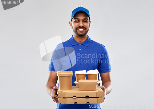 Image of happy indian delivery man with food and drinks