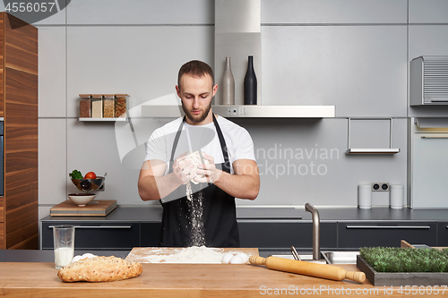 Image of Man mixing dough in the kitchen