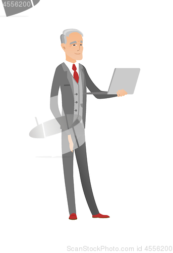 Image of Senior caucasian businessman using a laptop.