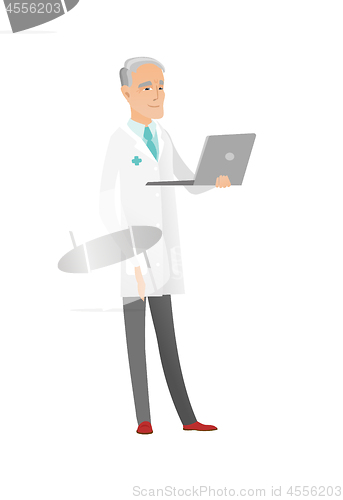 Image of Senior caucasian doctor using a laptop.