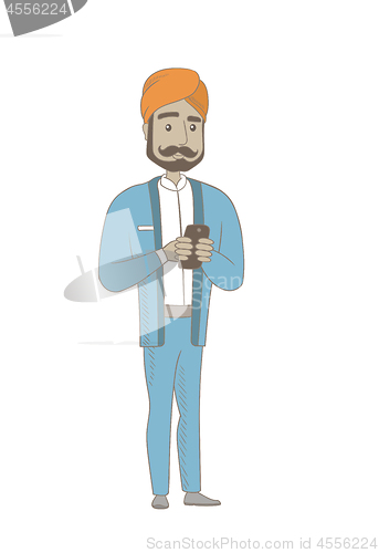 Image of Hindu businessman holding a mobile phone.