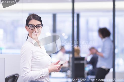 Image of Elegant Woman Using Mobile Phone in startup office building