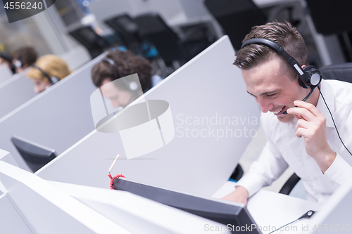 Image of male call centre operator doing his job