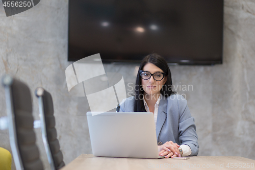 Image of businesswoman using a laptop in startup office