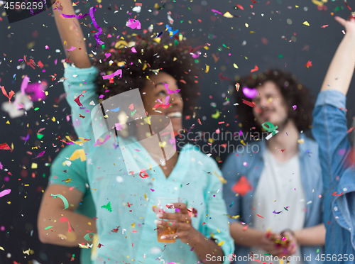 Image of confetti party multiethnic group of people isolated over gray