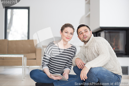 Image of Young Couple using digital tablet on cold winter day