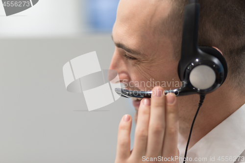 Image of male call centre operator doing his job