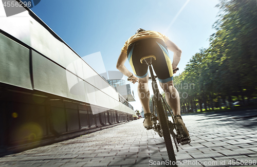 Image of Cyclist portrait on urban day scene