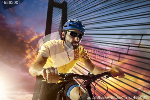 Image of Cyclist portrait on urban night scene