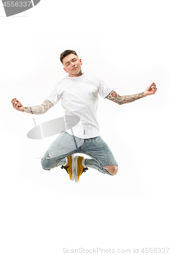 Image of Yoga in moving. handsome young man jumping against white background