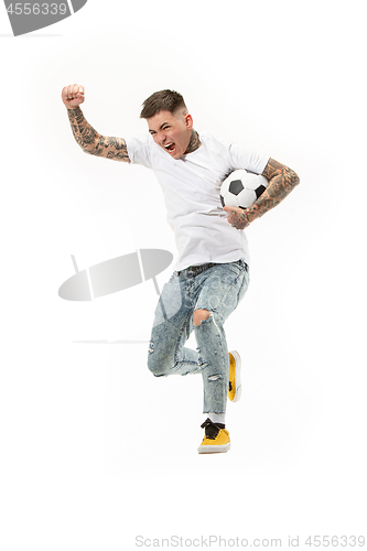 Image of The young man as soccer football player kicking the ball at studio