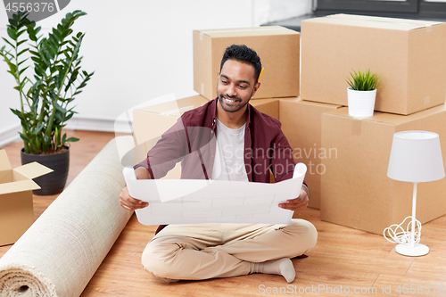 Image of man with boxes and blueprint moving to new home