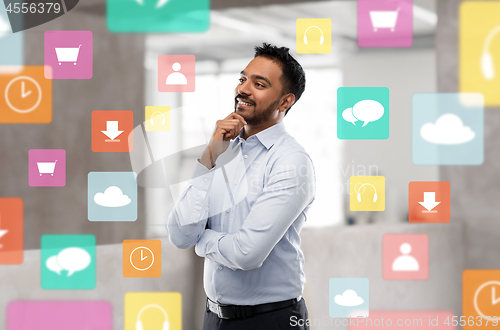 Image of indian businessman with app icons at office