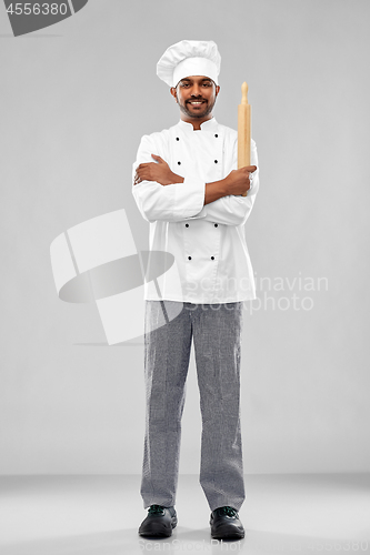 Image of happy male indian chef or baker with rolling-pin
