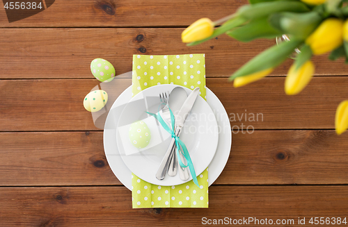 Image of easter egg in cup holder, plates and cutlery