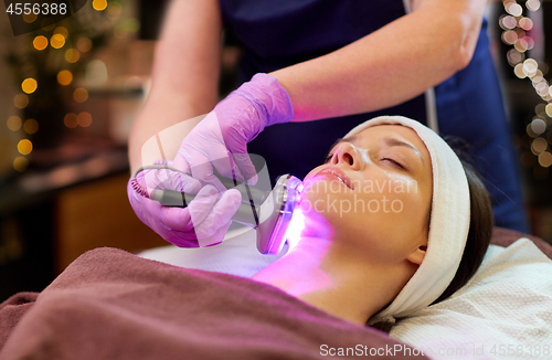 Image of young woman having face microdermabrasion at spa