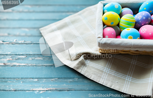 Image of close up of colored easter eggs in basket