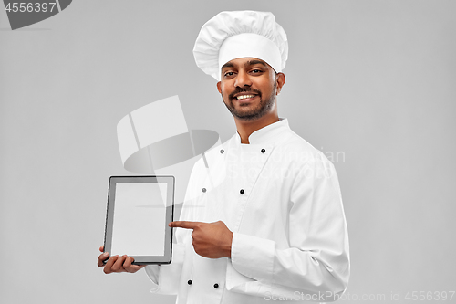 Image of happy male indian chef with tablet computer