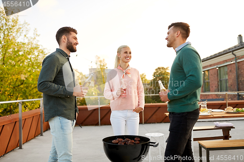 Image of happy friends having bbq party on rooftop