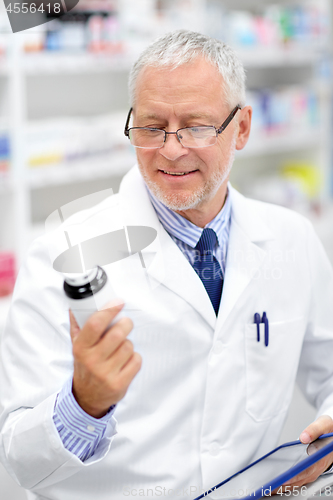 Image of senior with tablet pc at pharmacy