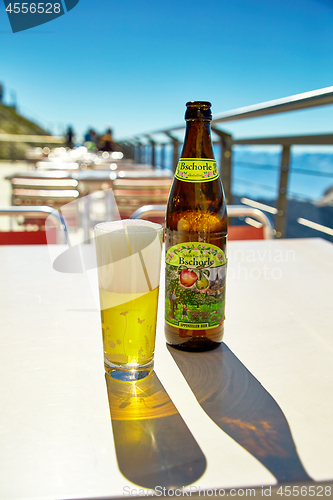 Image of Bottle and glass of popular non alcoholic apple beer in restaura