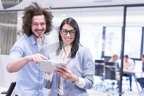 Image of Business People Working With Tablet in startup office