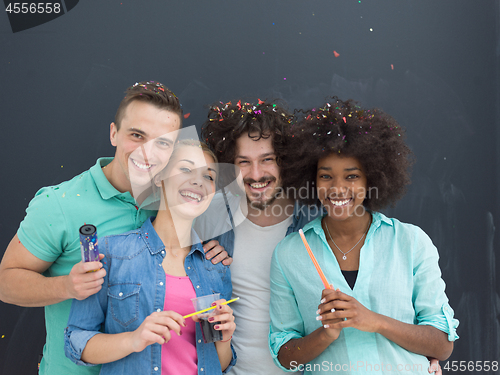 Image of confetti party multiethnic group of people isolated over gray