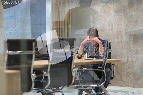 Image of young businessman relaxing at the desk