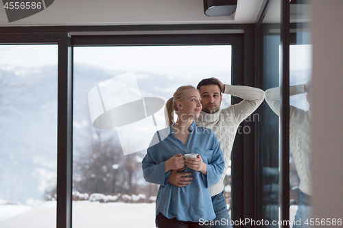 Image of young couple enjoying evening tea by the window