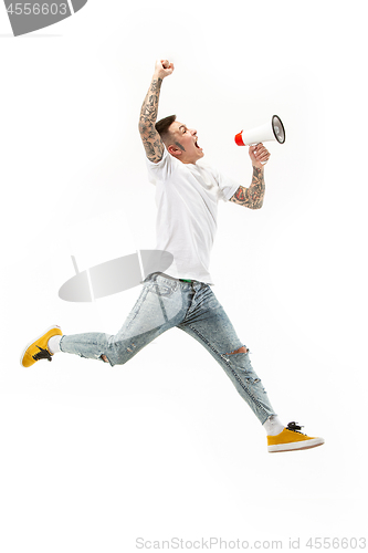 Image of Jumping fan on white background. The young man as soccer football fan with megaphone