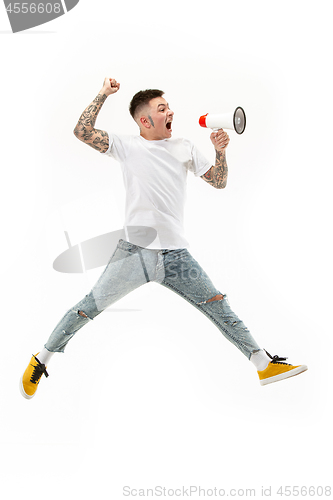 Image of Jumping fan on white background. The young man as soccer football fan with megaphone