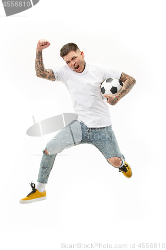 Image of The young man as soccer football player kicking the ball at studio