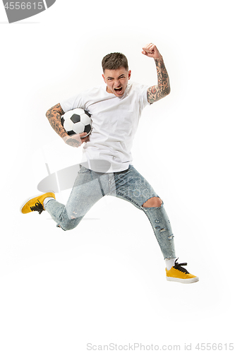 Image of The young man as soccer football player kicking the ball at studio