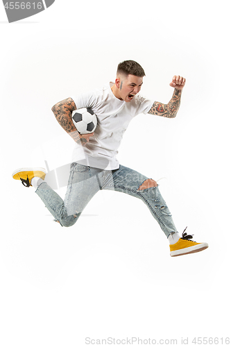 Image of The young man as soccer football player kicking the ball at studio