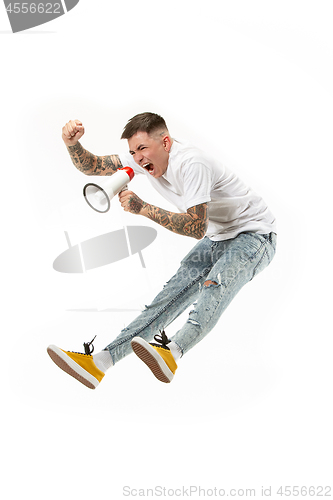 Image of Jumping fan on white background. The young man as soccer football fan with megaphone