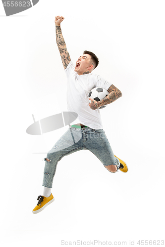 Image of The young man as soccer football player kicking the ball at studio