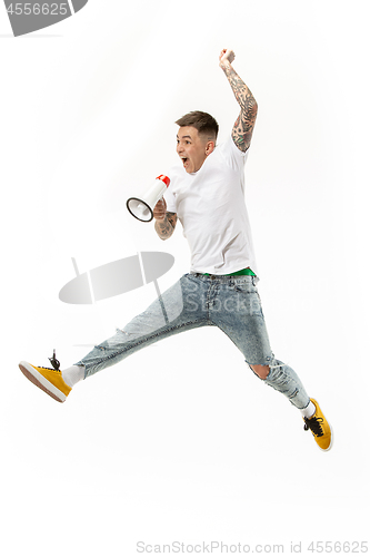 Image of Jumping fan on white background. The young man as soccer football fan with megaphone