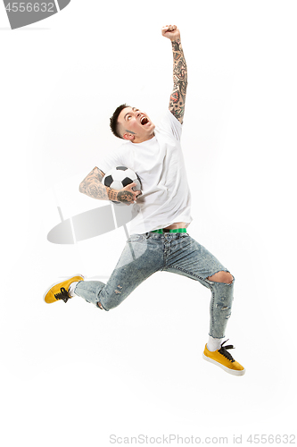 Image of The young man as soccer football player kicking the ball at studio