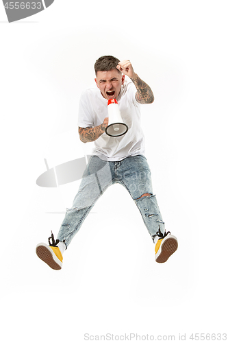 Image of Jumping fan on white background. The young man as soccer football fan with megaphone
