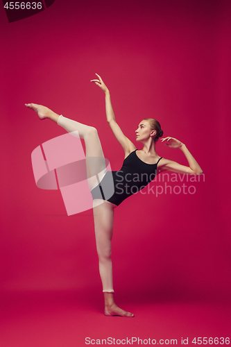 Image of Young teen dancer on red studio background.