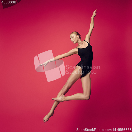 Image of Young teen dancer on red studio background.