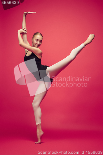Image of Young teen dancer on red studio background.