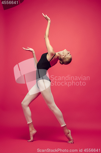 Image of Young teen dancer on red studio background.