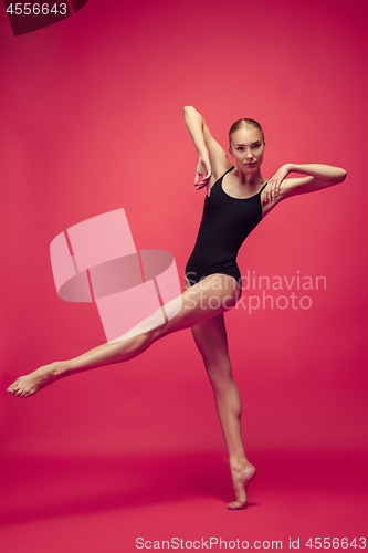 Image of Young teen dancer on red studio background.