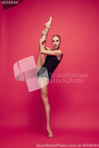 Image of Young teen dancer on red studio background.