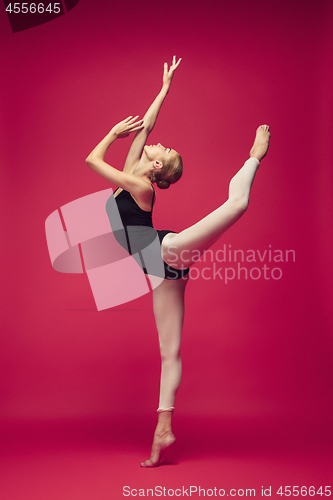 Image of Young teen dancer on red studio background.