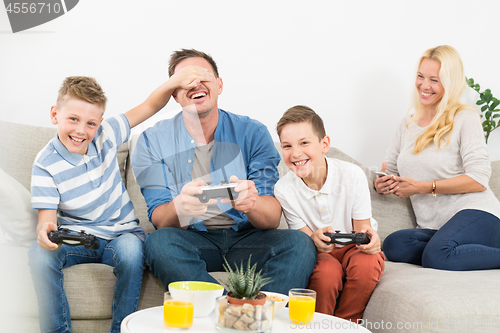 Image of Happy young family playing videogame On TV.